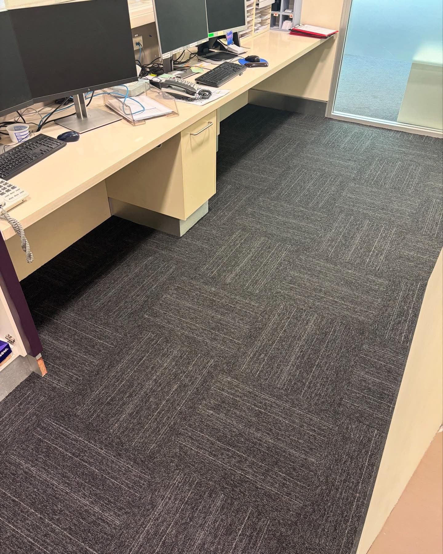 Office workstation area with dark charcoal loop-pile carpet tiles — Cardiff