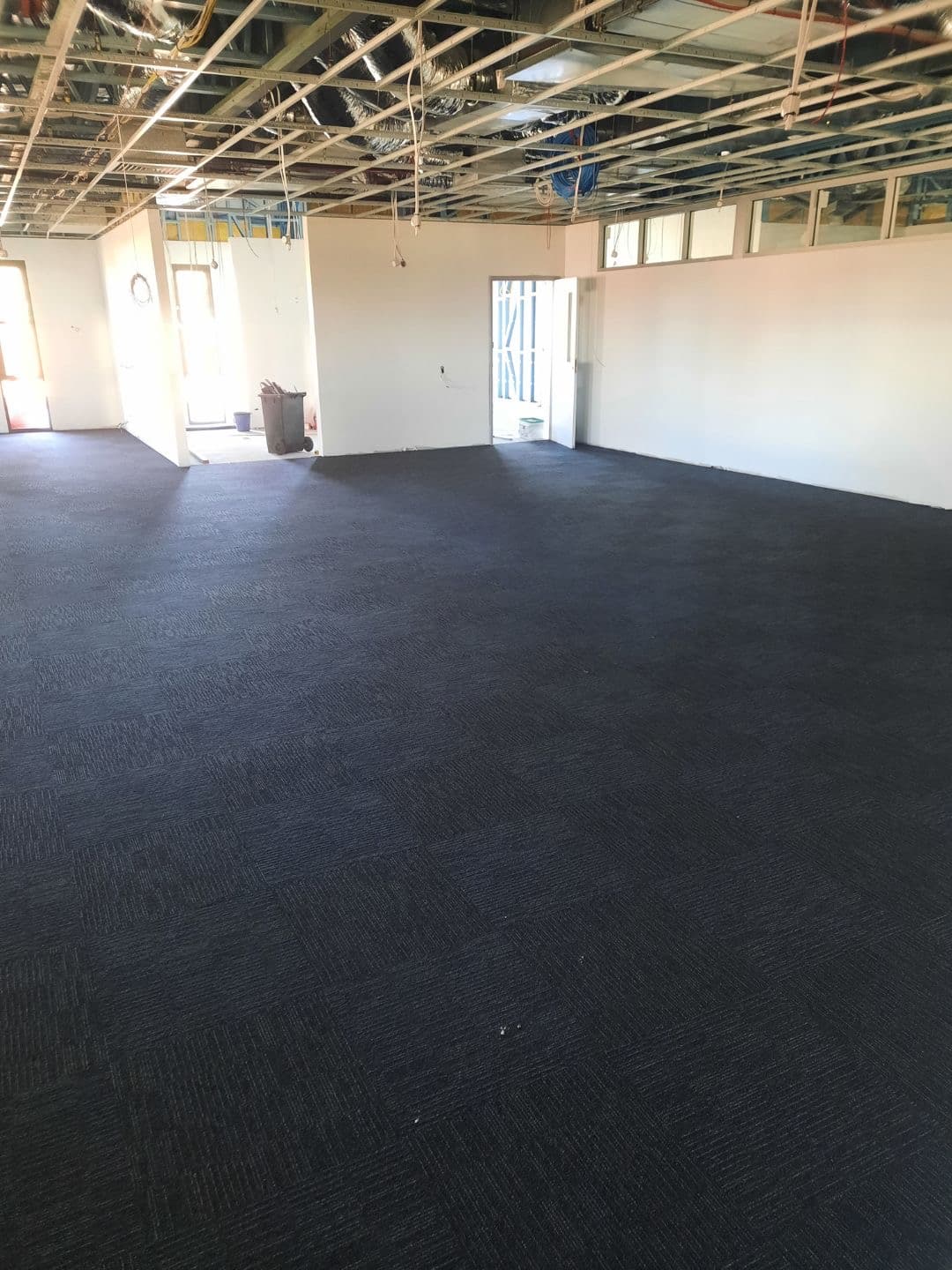 Dark navy Milliken carpet tiles installed across large open crew room area — Narrabri Fire Station
