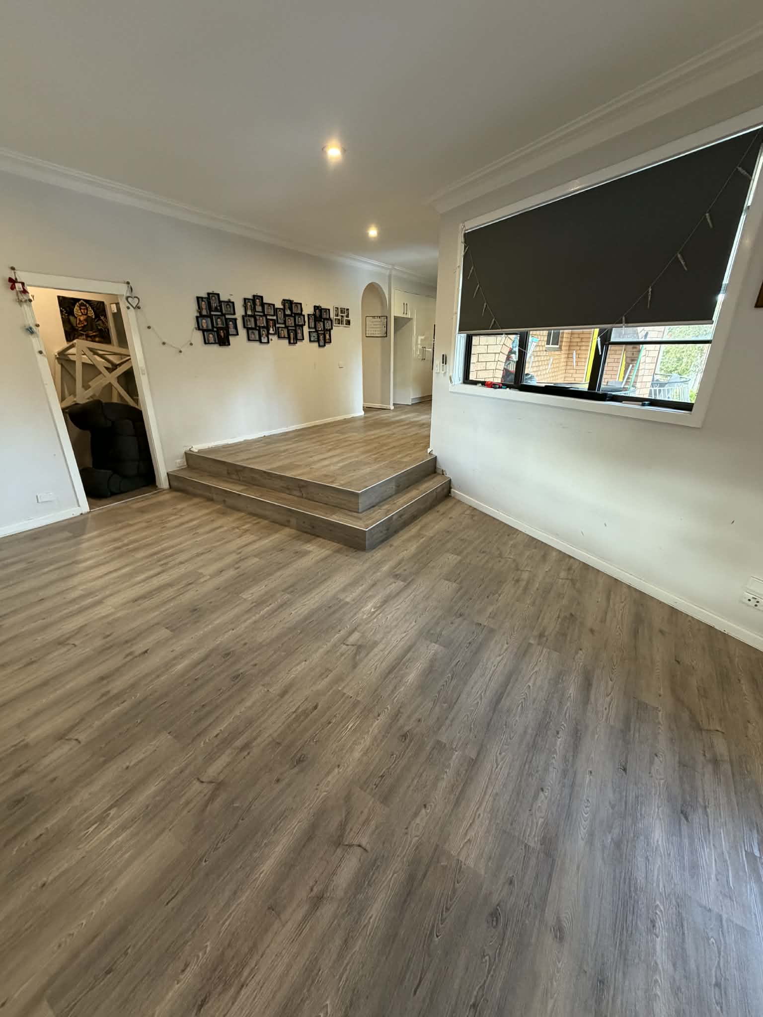 Open plan living area with vinyl plank flooring and raised platform step — Charlestown